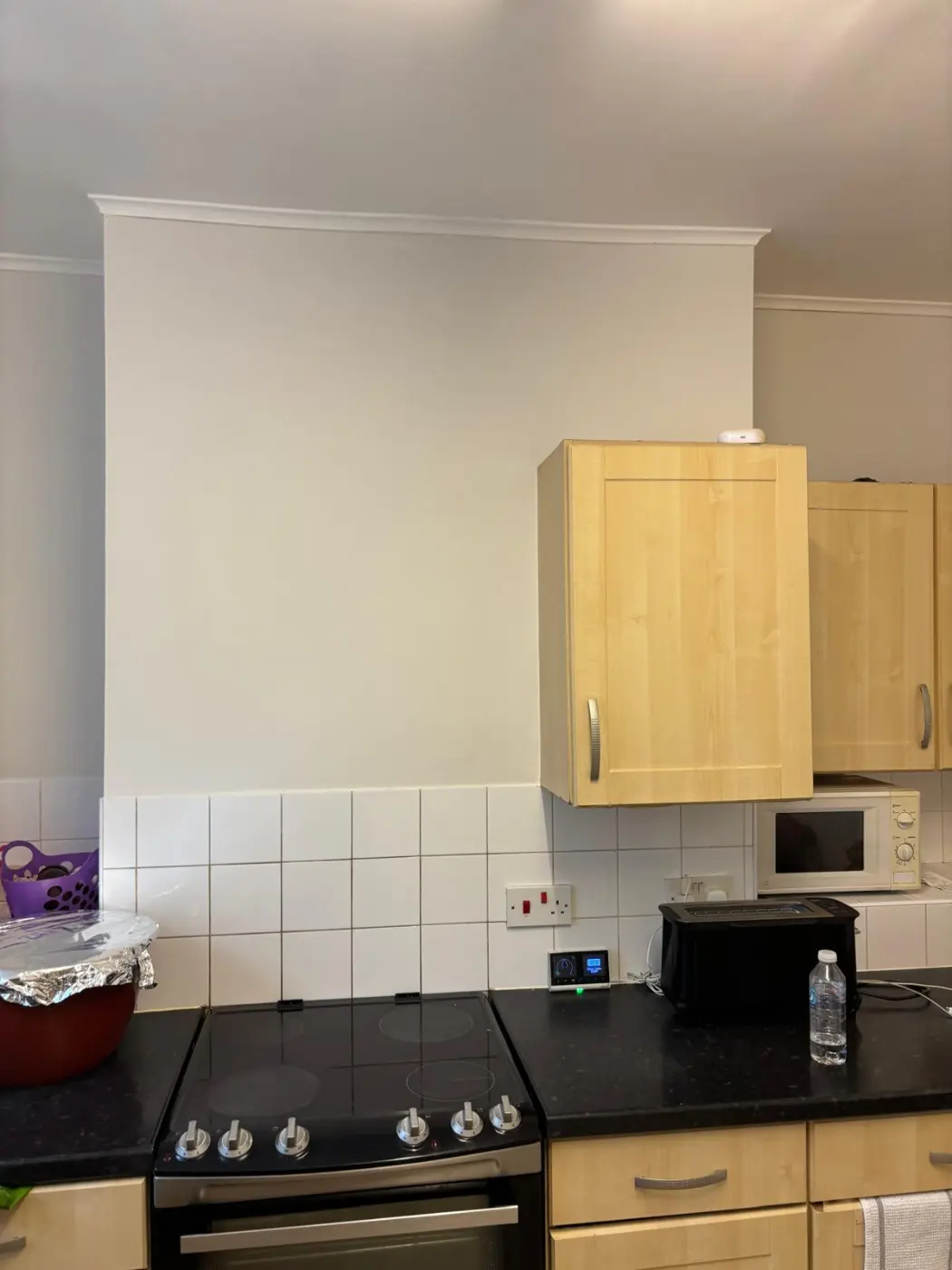 After: the completed wall finish around the retained kitchen